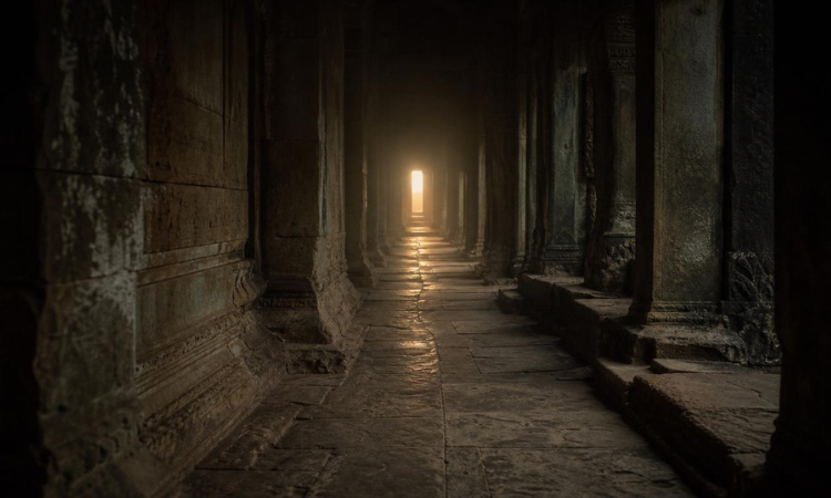 Ancient corridor with distant light symbolizing recorded spiritual events and the search for deeper truth.